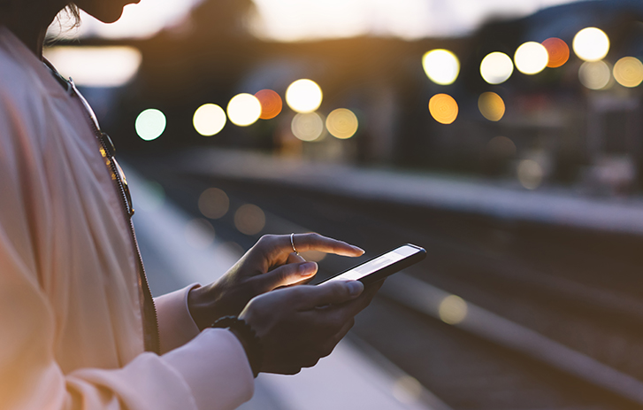 Person tapping phone at Twilight