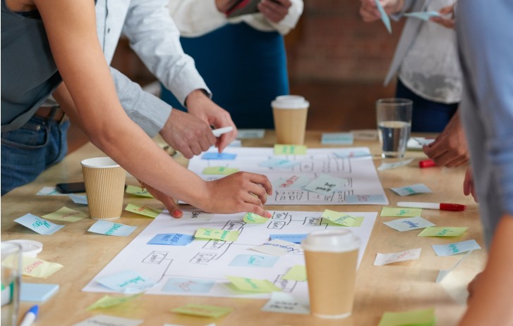 people working at table with paper
