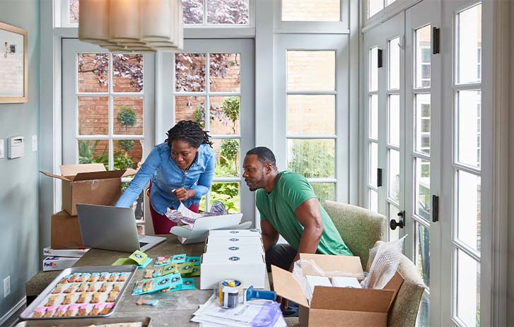 Man and woman looking at a computer.