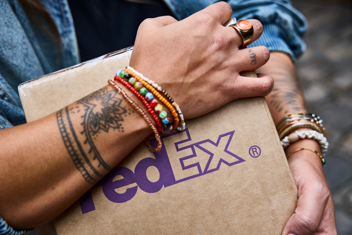 A person holding a FedEx package.