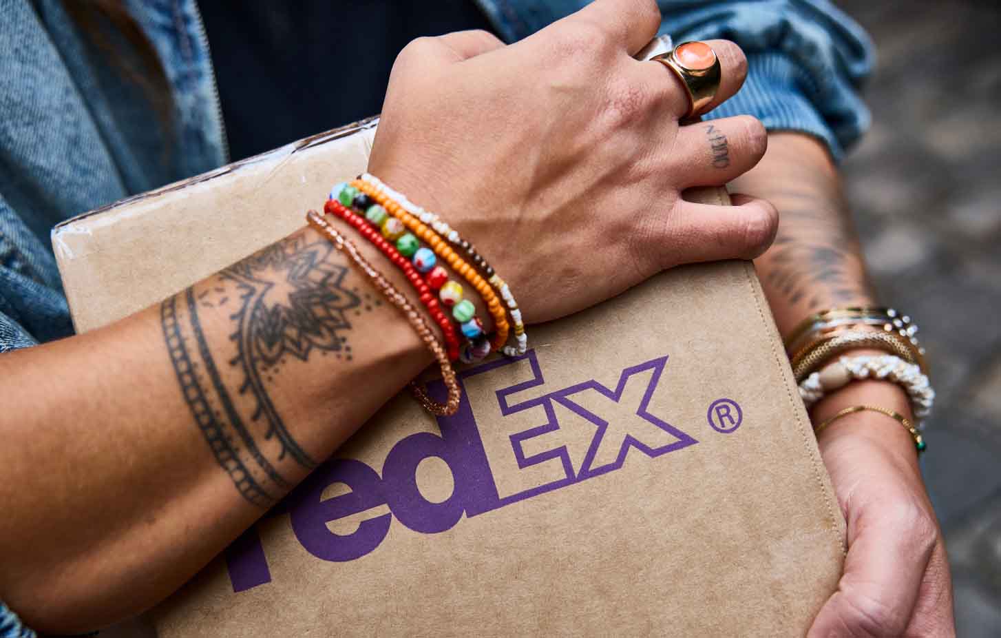 A person holding a FedEx package.