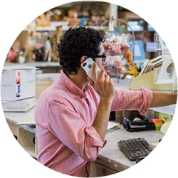 Small business employee helping customer by phone