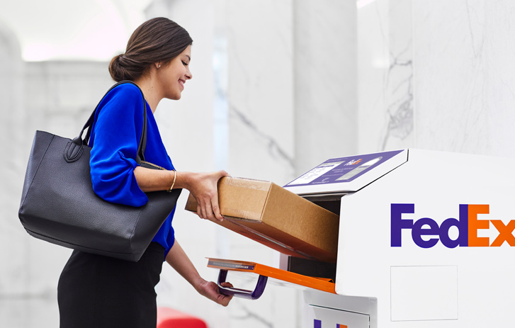 Woman putting package in FedEx Dropbox